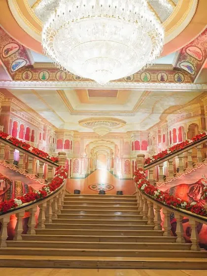 I transformed this palace venue by decorating the grand staircase with rich red florals, creating a breathtaking pathway. The combination of the venue's architecture, a massive crystal chandelier, and my decor work resulted in an atmosphere of pure royalty.