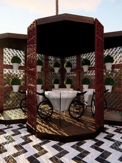 A unique dining setup inside a semi-private gazebo on a terrace. The bold black-and-white flooring and intricate latticework create a visually stunning and intimate space.