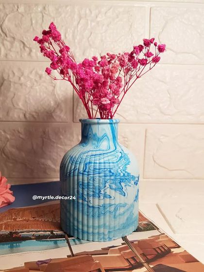 Our blue marbled Jesmonite vase styled with bright pink flowers. The contrast between the cool blue and vibrant pink is just beautiful.