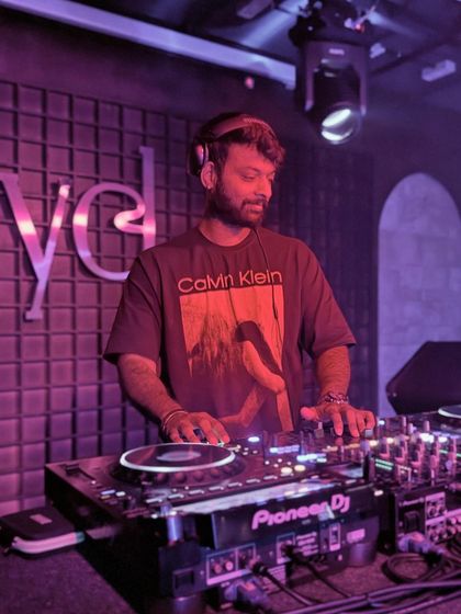 Focused on the mix at Level. The purple lighting and sound-paneled walls create an intimate but intense clubbing environment.