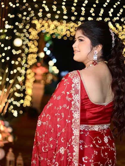 A view of the beautiful ponytail hairstyle and the glowing makeup from the back. This look is perfect for a reception, keeping the hair off her face while still looking elegant.