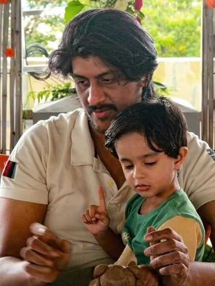A father and son work together on their clay Ganesha. Our events are designed to be inclusive and fun for the whole family.