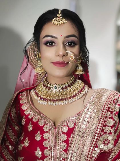 A close-up portrait of a lovely bride. I used soft purple and pink tones on her eyes to add a touch of modern color to her traditional red outfit.
