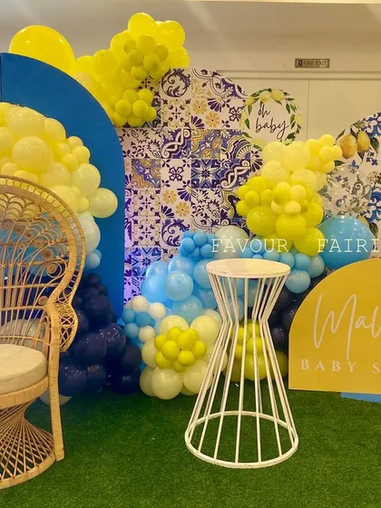 A vibrant Amalfi coast inspired baby shower for Mallika. We used bold blue and yellow colors, a lemon-and-tile pattern, and a wicker peacock chair to create a sunny and cheerful atmosphere.