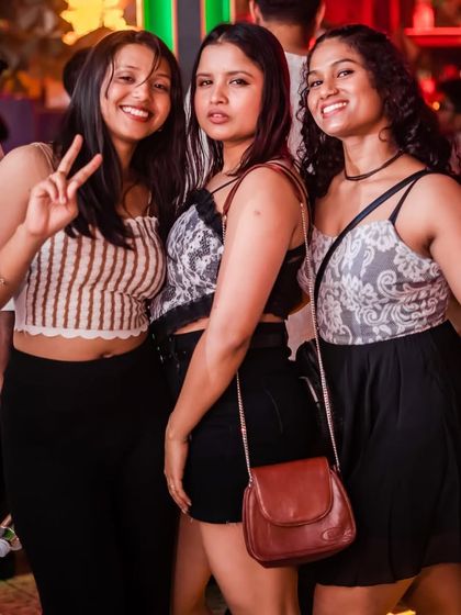 "A night without music is like a day without sunshine." These ladies are all smiles, enjoying the music and the company.