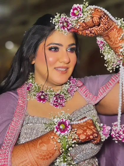 A happy bride-to-be at her Haldi ceremony. The makeup is soft and dewy, with a pop of shimmer on the eyes to catch the light.