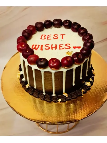 A simple chocolate truffle cake for an office farewell. Topped with fresh cherries and a white chocolate drip, it's an elegant way to say "Best Wishes".