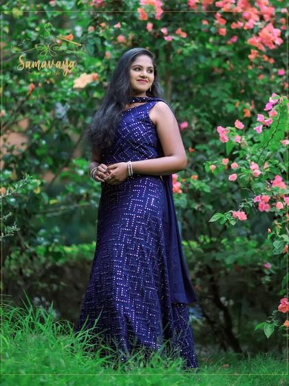 This elegant blue sequined lehenga shines beautifully in a green, natural environment. It's a great choice for an evening outdoor event or pre-wedding shoot.