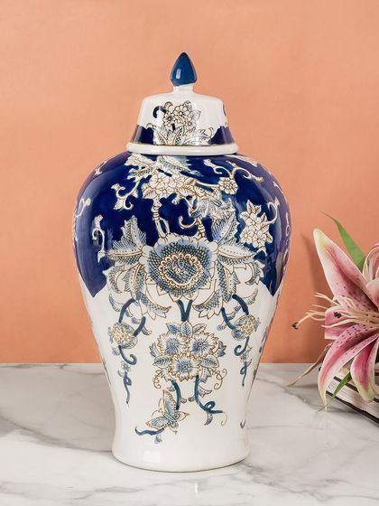 This blue and gold ceramic ginger jar offers a luxurious take on the classic design. The gold accents highlight the floral patterns, making it a particularly opulent decorative vase for your home.