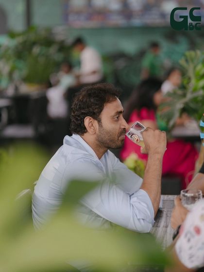 Taking a moment to enjoy a sip of cold beer amidst the lively ambiance.