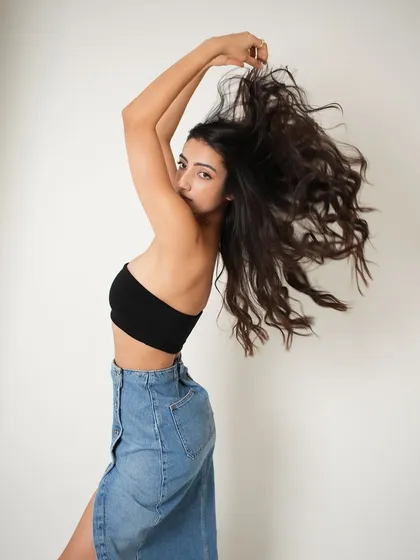 A dynamic shot with beautiful movement in the hair. The makeup remains flawless, proving its staying power even during an active photoshoot.