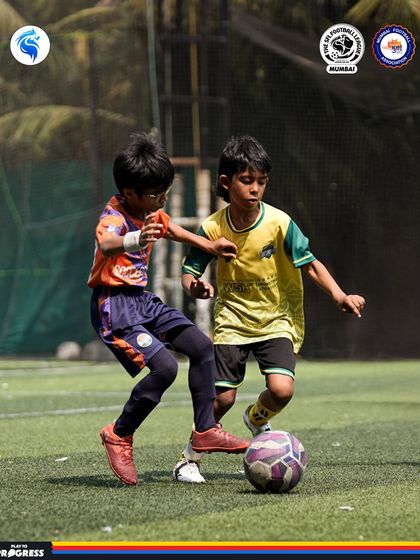 Two players competing for possession. The intensity of our league matches helps players develop resilience and composure under pressure.