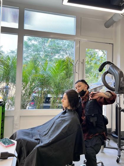A quiet moment of focus while working on a client's haircut. The craft is in the details.