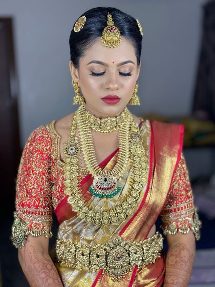 A close up of this bride's stunning Muhurtham makeup. The bold red lip and defined eyes are classic choices that never go out of style.