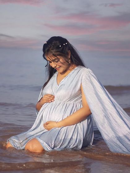Embracing the waves and the moment. This mom-to-be looks so happy sitting in the water, with the light blue caped gown floating around her. My dresses are designed to look beautiful even in dynamic, natural settings.