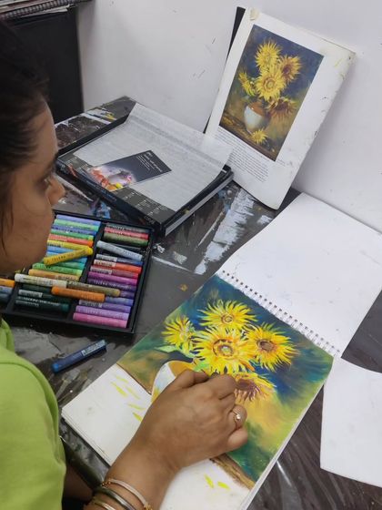 An adult student uses oil pastels to recreate a famous sunflower painting, learning blending techniques for this rich medium.