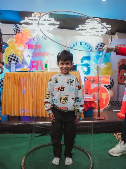A magical moment as a young birthday boy is encased in a giant bubble. This is the highlight of my bubble show and makes for an incredible photo.