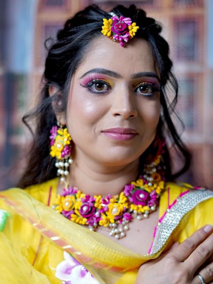 A close-up of the colorful eye makeup, perfectly complementing the floral jewelry.
