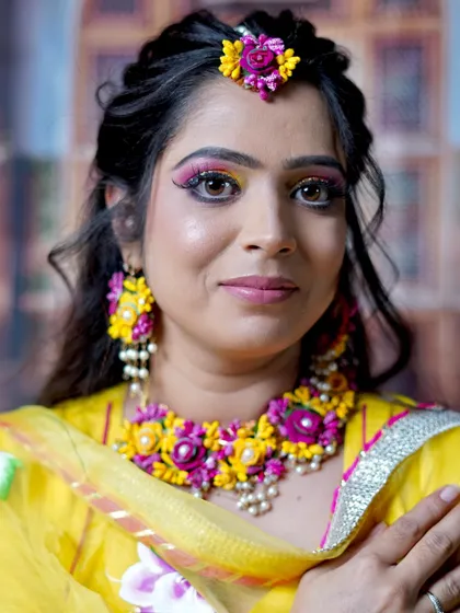 A close-up of the colorful eye makeup, perfectly complementing the floral jewelry.