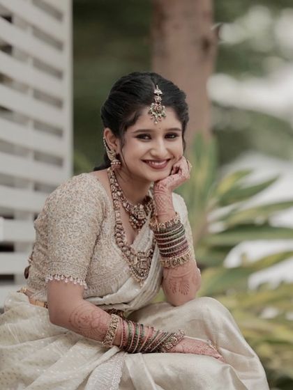 A beautiful, happy portrait of Ramya, the sister of the bride. Her makeup is soft and radiant, perfect for a daytime wedding event.