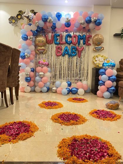 A different perspective of the gender-neutral 'Welcome Baby' decoration, showing the flower rangoli on the floor.