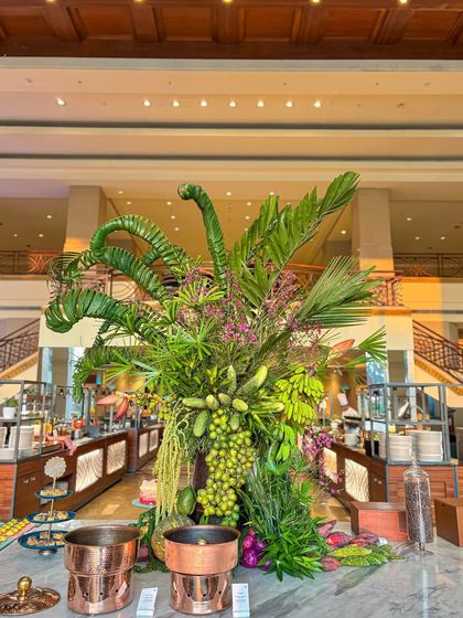 A wider view of the nature-inspired buffet. The towering green arrangement acts as a central sculpture, turning the dining area into an adventure.