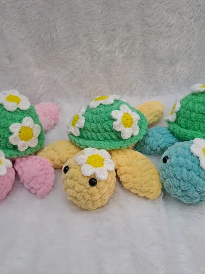 My daisy turtle plushies are so cheerful. Made with soft, chunky yarn, they come in a variety of pastel colors like pink, yellow, and blue.