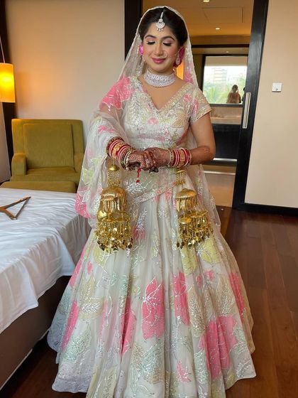 The bride looks like a princess in her beautiful floral lehenga.