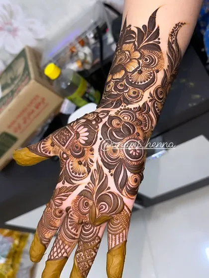 A clear, well-lit shot of a full bridal hand design. You can see the precision in every line and the depth created by the shading.