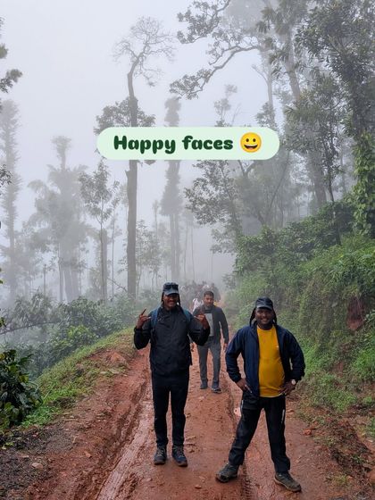 "Happy faces" indeed. Two trekkers smiling on a muddy trail surrounded by misty forests during a Nethravathi trip.
