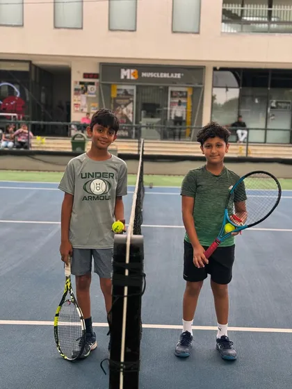 Two friends and players at the net. Our academy is a place where lasting friendships are forged on and off the court.