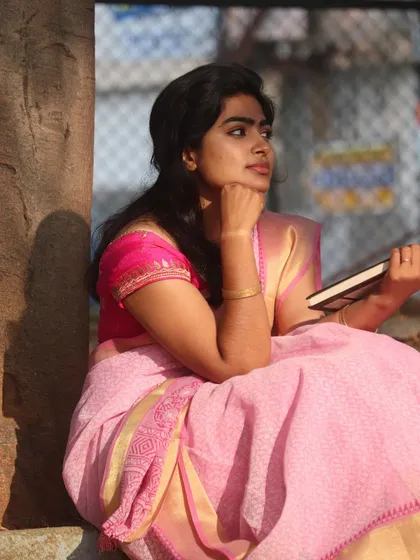 A thoughtful pose, showing how the makeup looks natural even in a candid, thinking moment.
