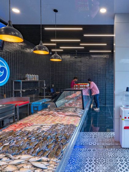 The fresh fish counter is designed for both hygiene and visual appeal. I used durable, easy-to-clean tiles and focused pendant lighting to create a clean, modern, and trustworthy specialty food area.