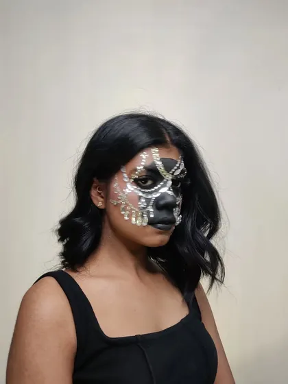 A straight-on shot of the rhinestone mask, showing the full, symmetrical design.
