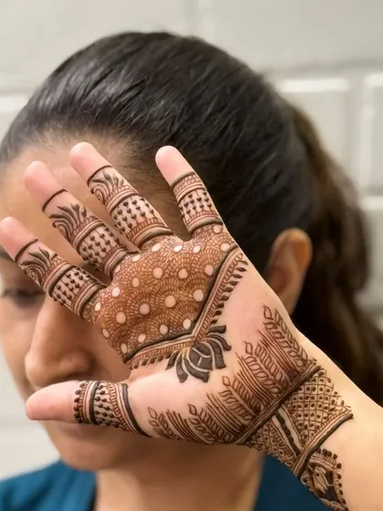 Another candid pose with this beautiful and modern henna design.