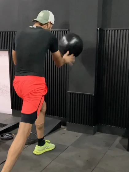Another angle of a rotational medicine ball throw, emphasizing the hip drive and follow-through.
