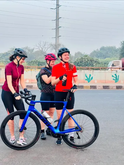 Three friends admiring a new bike.