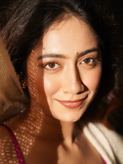 Playing with light and shadow. The patterned light adds interest, but the skin still looks fresh and luminous underneath.