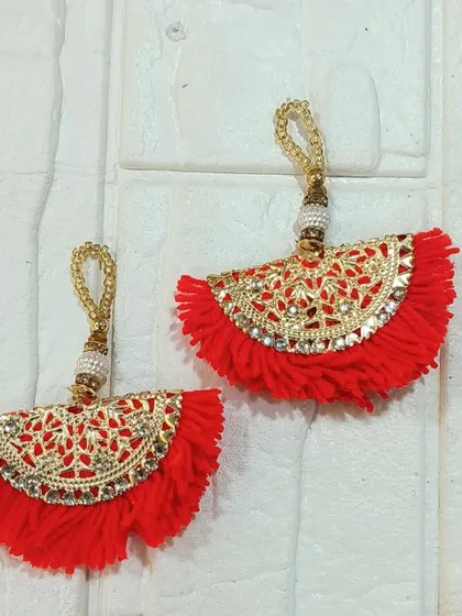 These red fan-shaped tassels are another vibrant option from our collection. Their intricate gold work adds a touch of elegance and festivity.
