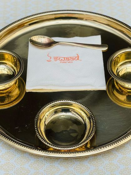 The elegant design of the gold thali, with its beaded rim and matching bowls, is chosen specifically to complement the premium quality of the food I serve.