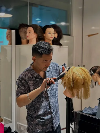 An instructor demonstrates a cutting technique on a mannequin, with other mannequins ready for the students to practice on. This is how we ensure consistent, high-quality training.