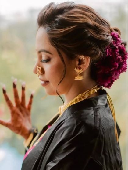 A side profile of the bride, showing how the floral bun adds a touch of softness and romance to her look.