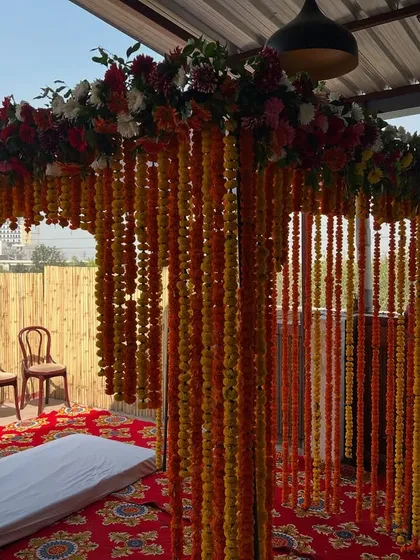 A different angle of the outdoor marigold mandap, showing how it looks against the open sky.