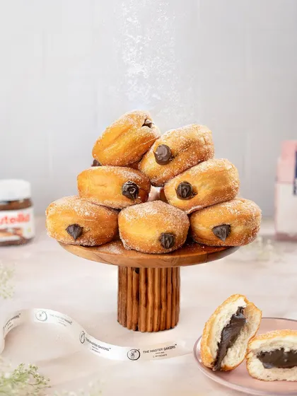 A tower of our classic Berliners, generously filled with rich chocolate and dusted with powdered sugar. These pillowy soft donuts are an irresistible treat.