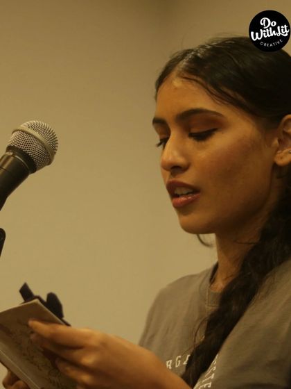 A poet sharing her work from her notebook. It's a space for raw, honest expression.