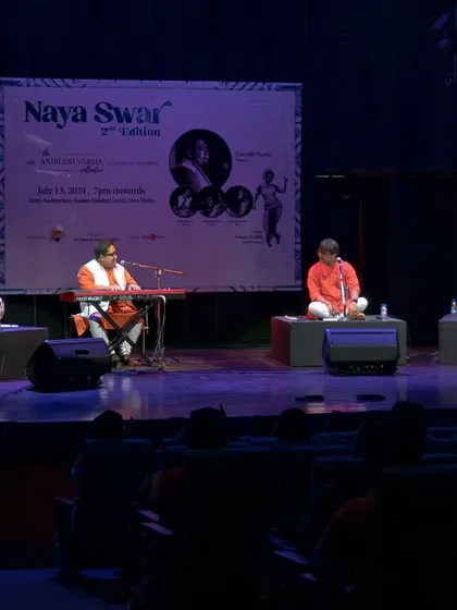 A wide shot of the AVC Classical Quartet on stage at the India Habitat Centre. Our quartet setup features vocals, piano, tabla, and sitar, creating a unique soundscape.