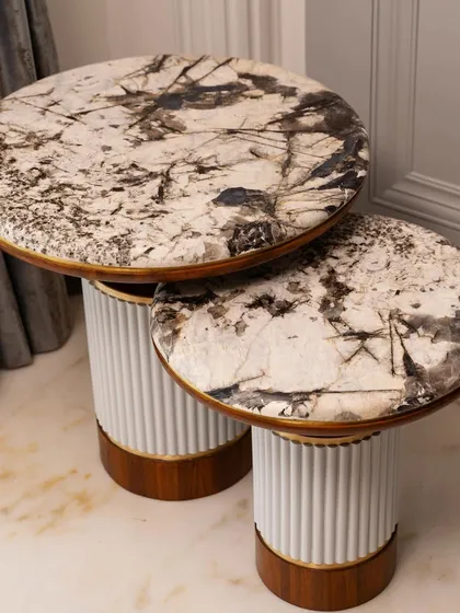 The new set of two side tables, featuring marble tops, wood finish, and brass details to enhance the living room's aura.