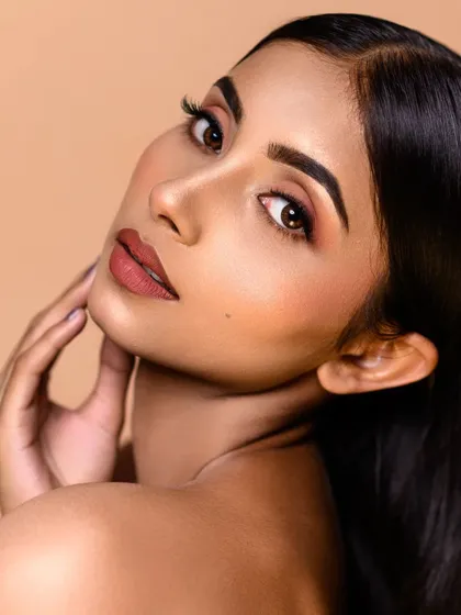 This beauty shot showcases a flawless complexion and perfectly applied makeup. The neutral background and soft lighting make it a timeless addition to any portfolio.
