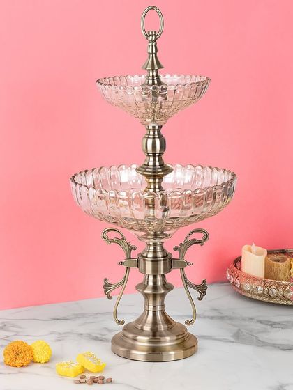 This two-tier serving stand is perfect for high tea or displaying festive treats. The combination of patterned glass bowls and an antique-finish metal stand creates an elegant and practical hosting accessory.