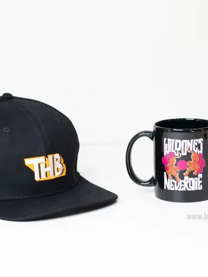 A custom black snapback cap and a matching black mug. This combination is a great gift idea for a modern and style-conscious team.